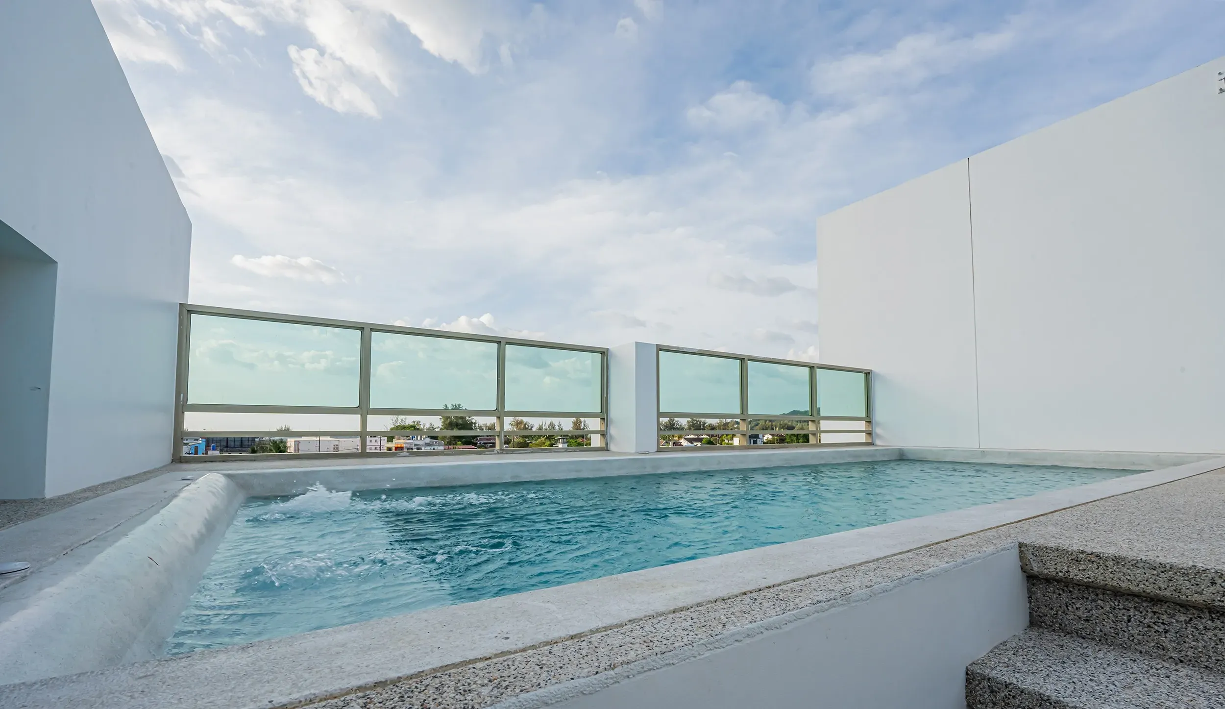 Infinity-edge swimming pool running elegantly along the side of the building