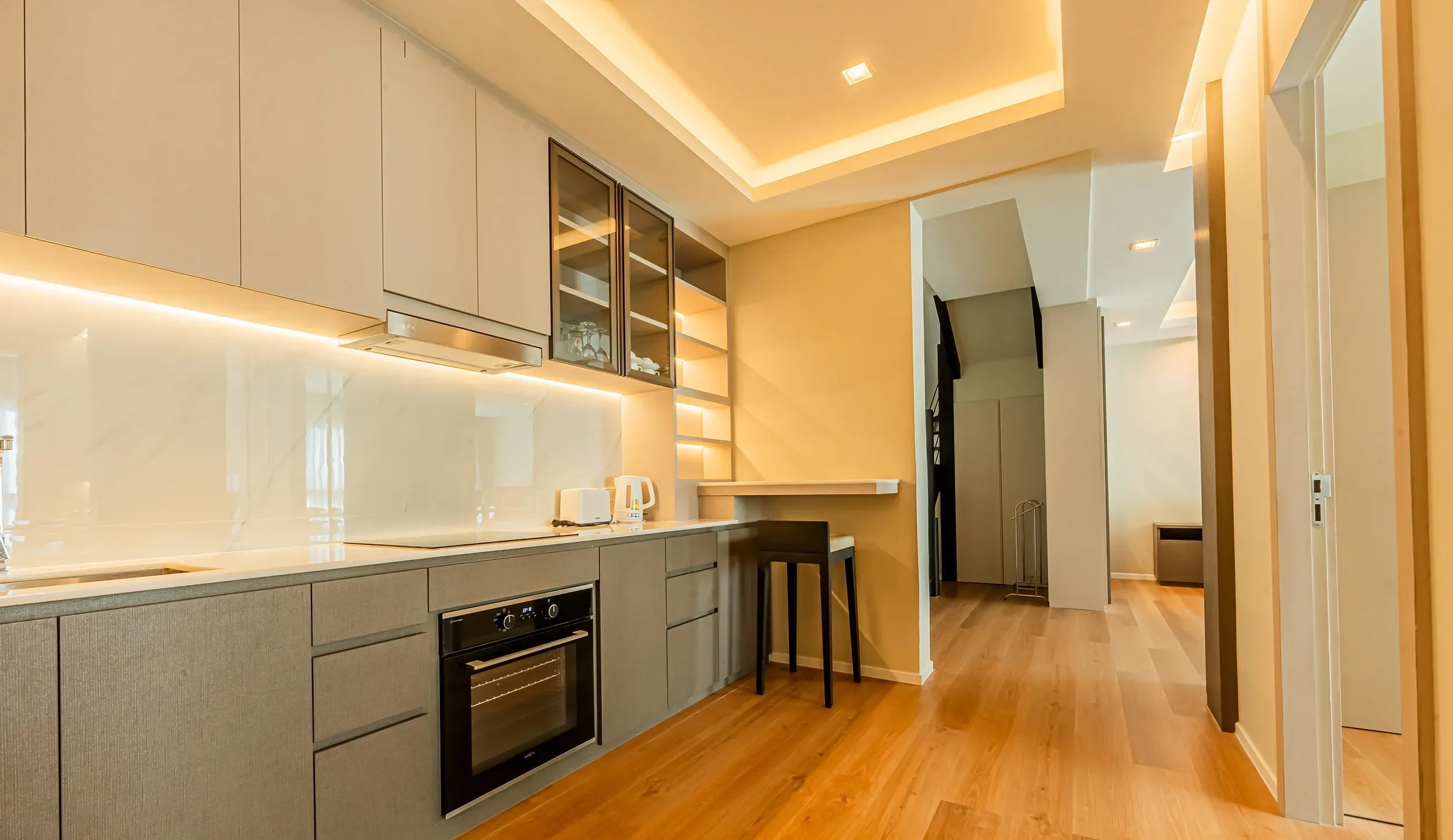 Sleek open-plan kitchen with a modern island counter and bar stools